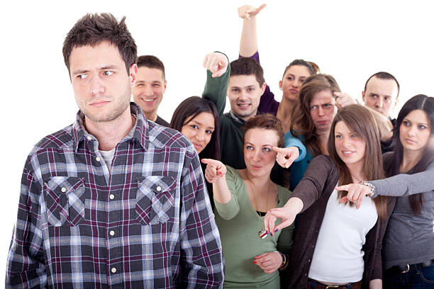 istock Crowd pointing fingers at a young man 183769415