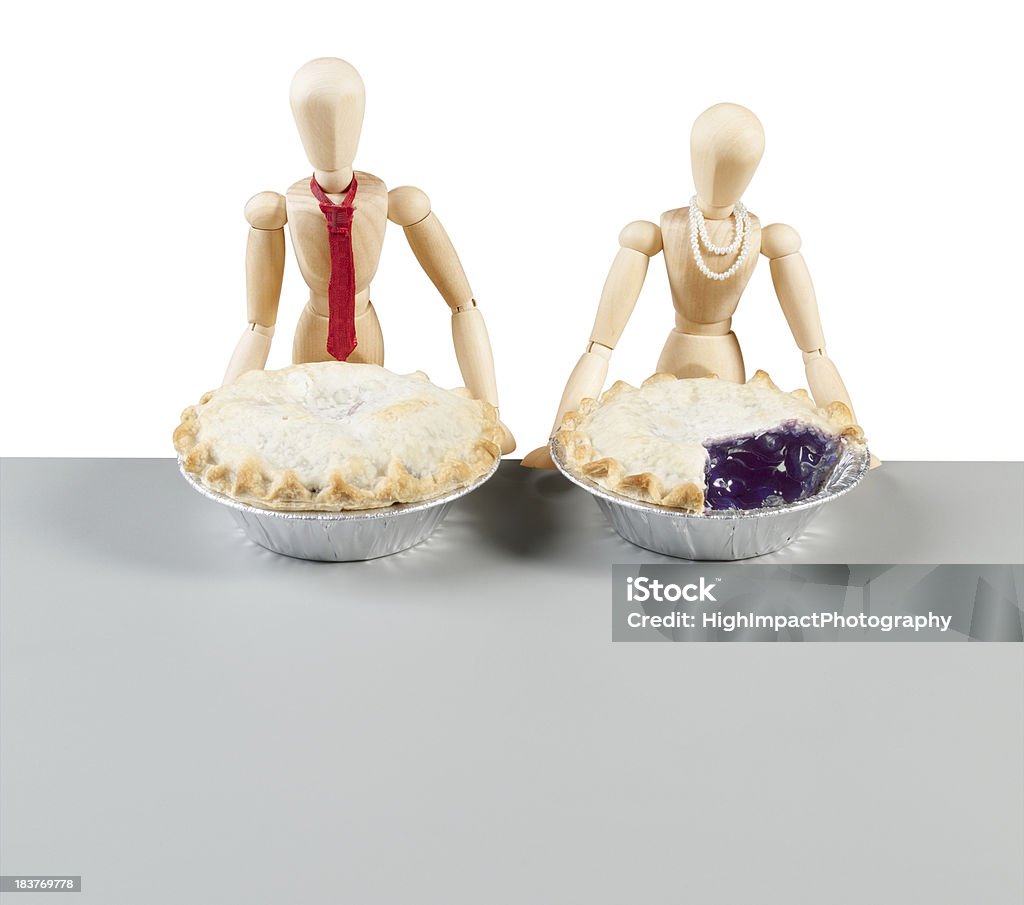 Pie Comparison Male and female wooden dolls show that the woman gets less. Blueberry Stock Photo