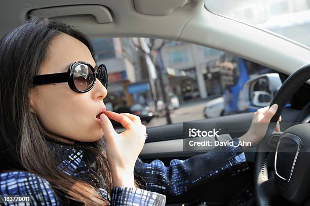 Giovane Donna Avendo Uno Spuntino Durante La Guida - Fotografie stock e altre immagini di Mangiare - Mangiare, Guidare, Automobile