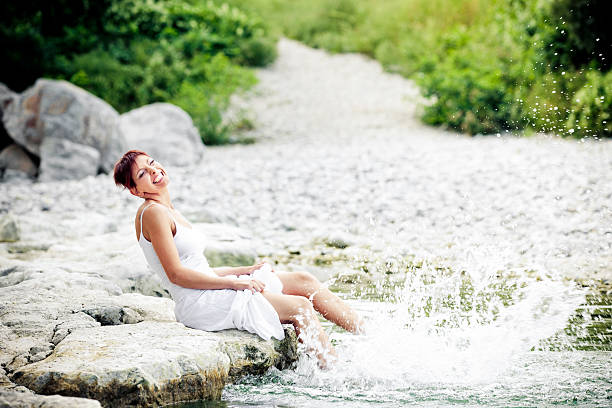 istock Young woman playing with water 183770145