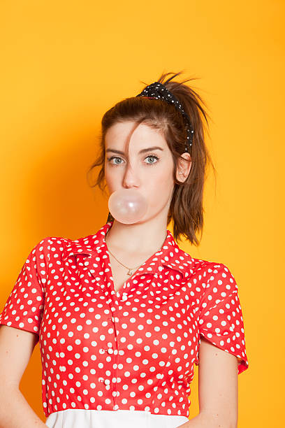 istock Young woman blowing bubblegum 183770151