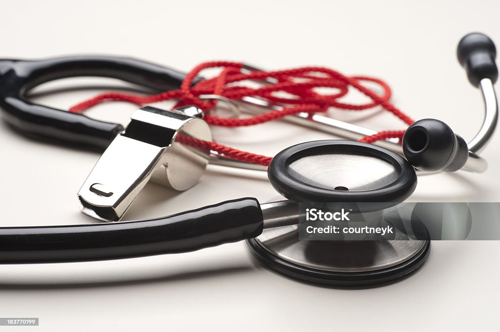 Sports medicine concept Stethoscope and referee whistle on white background Stethoscope Stock Photo