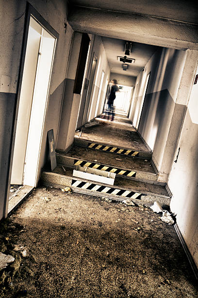 Empty damaged long corridor Old empty abandoned office building with motion blurred woman / Tonemapping / some noise if you look at fullsize schutt stock pictures, royalty-free photos & images