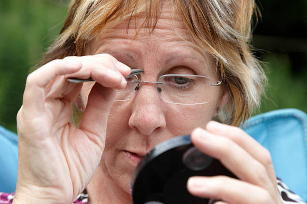 istock Mature woman plucking eyebrows 183770282