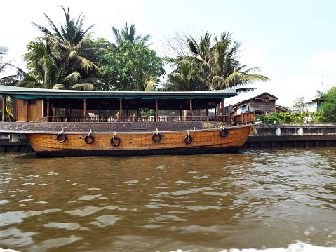 A double-decker passenger boat on the Chao Phraya River, it brings tourists to worship at various temples along the river.