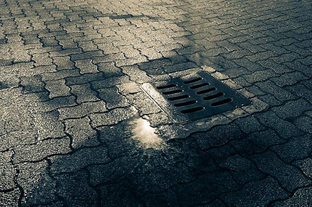 istock Manhole In The Rain And Puddle 183770327