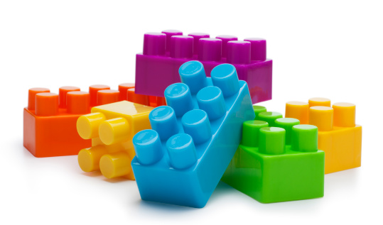 This is a photo of a building blocks isolated on a pure white background with a drop shadow. The focus is on the top of the front blocks and falls off a little bit on the back.Click on the links below to view lightboxes.