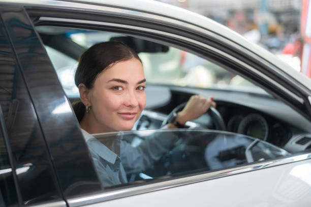istock A young beautiful woman driving her car 1837710551