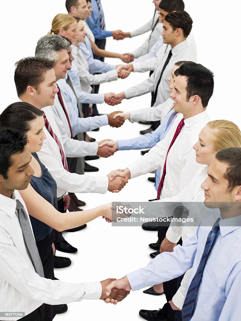 Businesspeople Shaking Hands High angle view of two rows of businesspeople shaking hands. Vertical shot. Adult Stock Photo