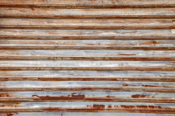 istock Rusted  bare metal security door background, rust and silver colors 183771389