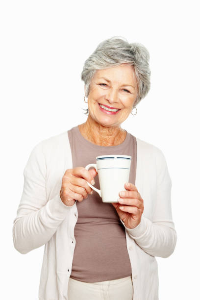 istock Elderly woman with coffee cup on white background 183771436
