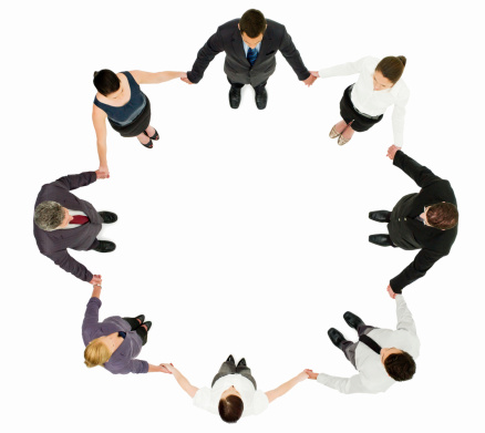 Overhead view of businessman and businesswomen holding hands in a circle. Isolated on white. Horizontal shot.