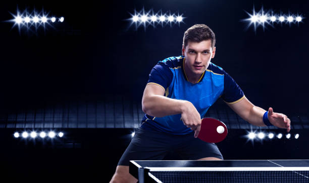 Table tennis player on the black background. Ping pong banner. Download a photo of a table tennis player for a tenis racket packaging design. Image for tennis ball box template. stock photo