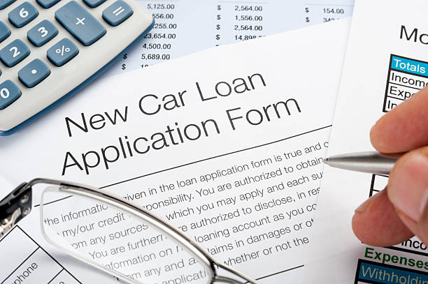istock Car loan application Form with pen, calculator, writing hand 183771722