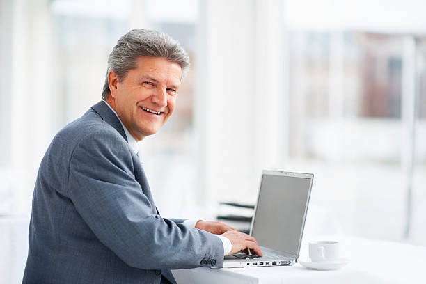 istock Smiling businessman with laptop 183771772