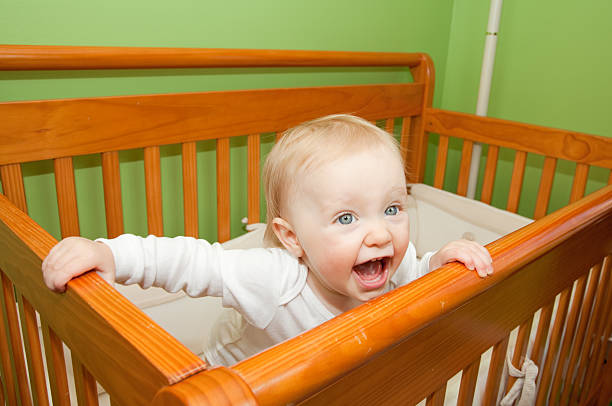 istock Baby girl in a crib 183771846