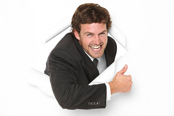 istock Businessman emerging through a hole in white paper 183772457