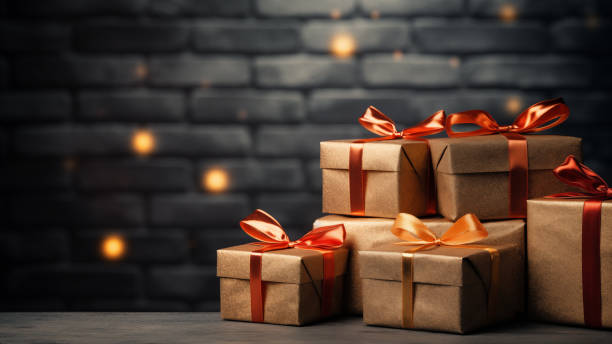 istock Brown Gift Boxes with Orange Ribbons and Bokeh 1837725446