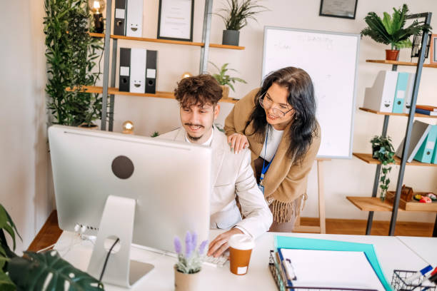 istock Colleagues working together in office in front of desktop PC 1837726879