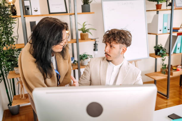 istock Colleagues working together in office in front of desktop PC 1837727386