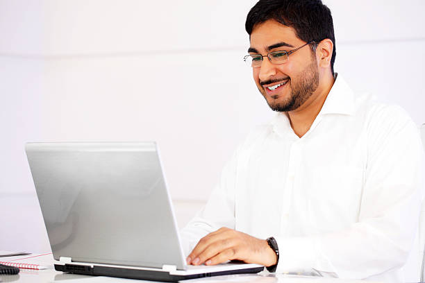 istock Cheerful Indian business man typing on laptop computer. 183772950