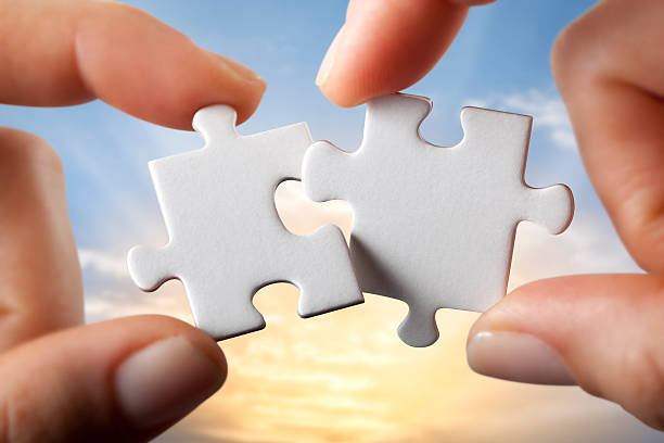 Hands trying to fit two puzzle pieces together. Some similar pictures from my portfolio: