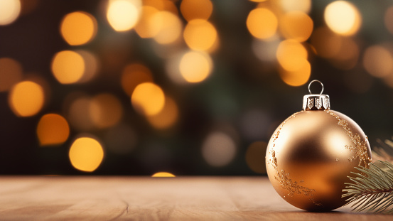 Golden Christmas Bauble on Bokeh Light Background