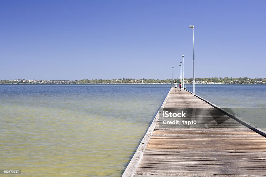 Jetty Couple jogging on jetty South Perth. Active Lifestyle Stock Photo