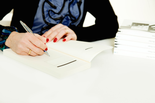 Woman writer autographing books.More like this (Direct links)