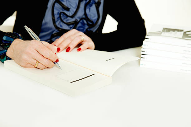 Author signing books stock photo