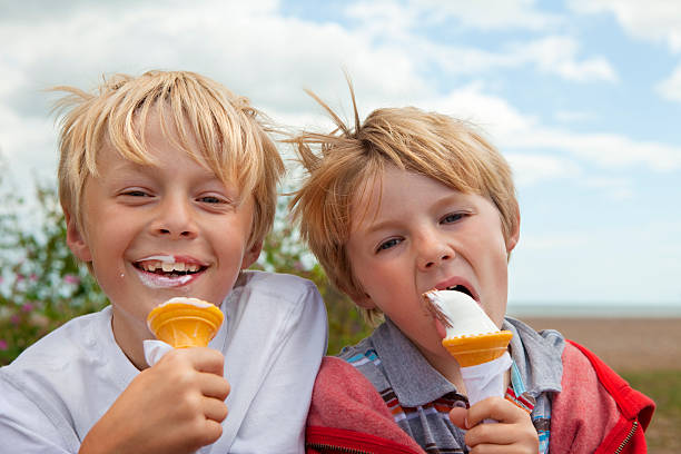 istock Boys enjoying eating icecreams on a summer holiday 183774260