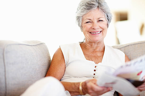 istock Woman holding magazine and smiling 183774297