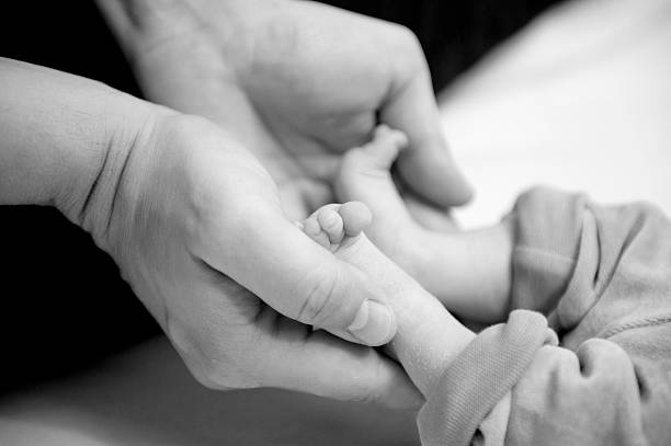 istock Newborn baby feet 183774973