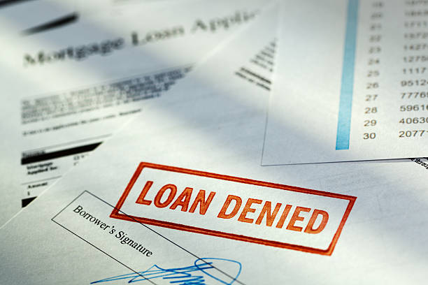 Mortgage Application Borrower Document with “Loan Denied” Red Rubber Stamp stock photo