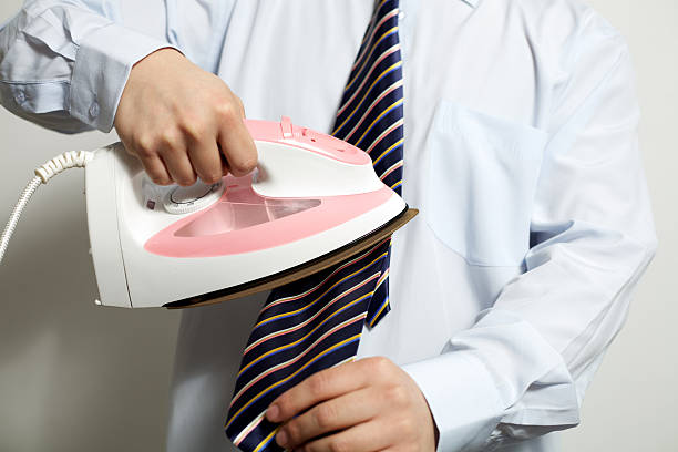 istock Businessman irons his tie 183775104