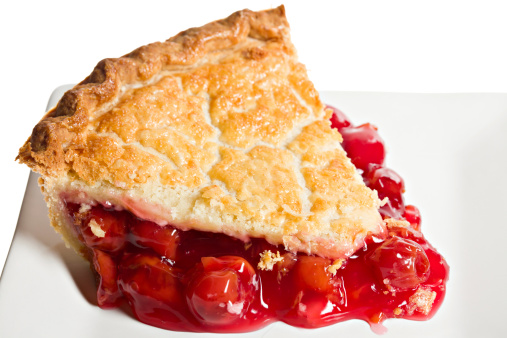 Macro slice of cherry pie on a white plate and isolated on white.