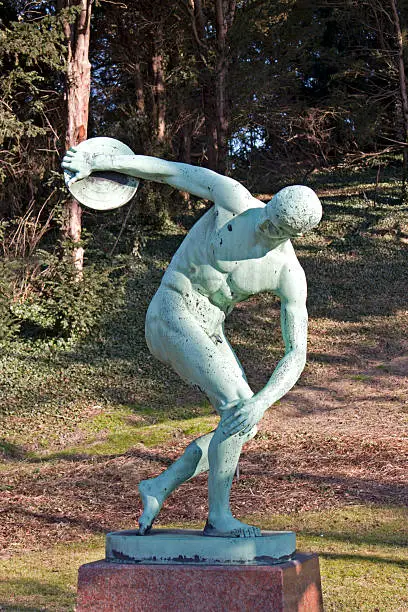 "Discobolos, the discos thrower.Copy of the Discobolos made by the Greek  sculptor  Myron of Eleutherae. He was working circa 480-440 BC. Found in Copenhagen Botanical garden, Denmark."