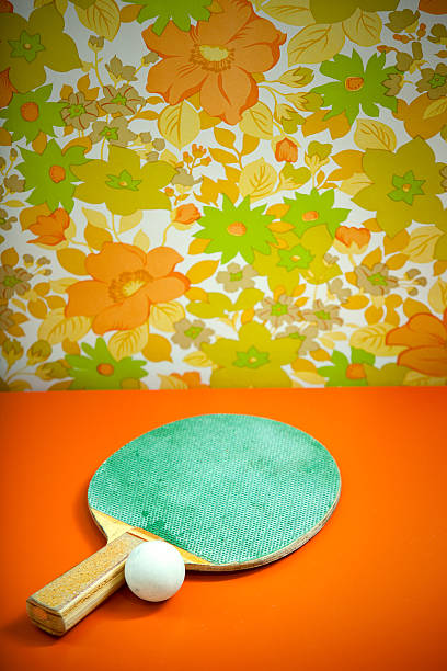Black ping pong paddle on blue background