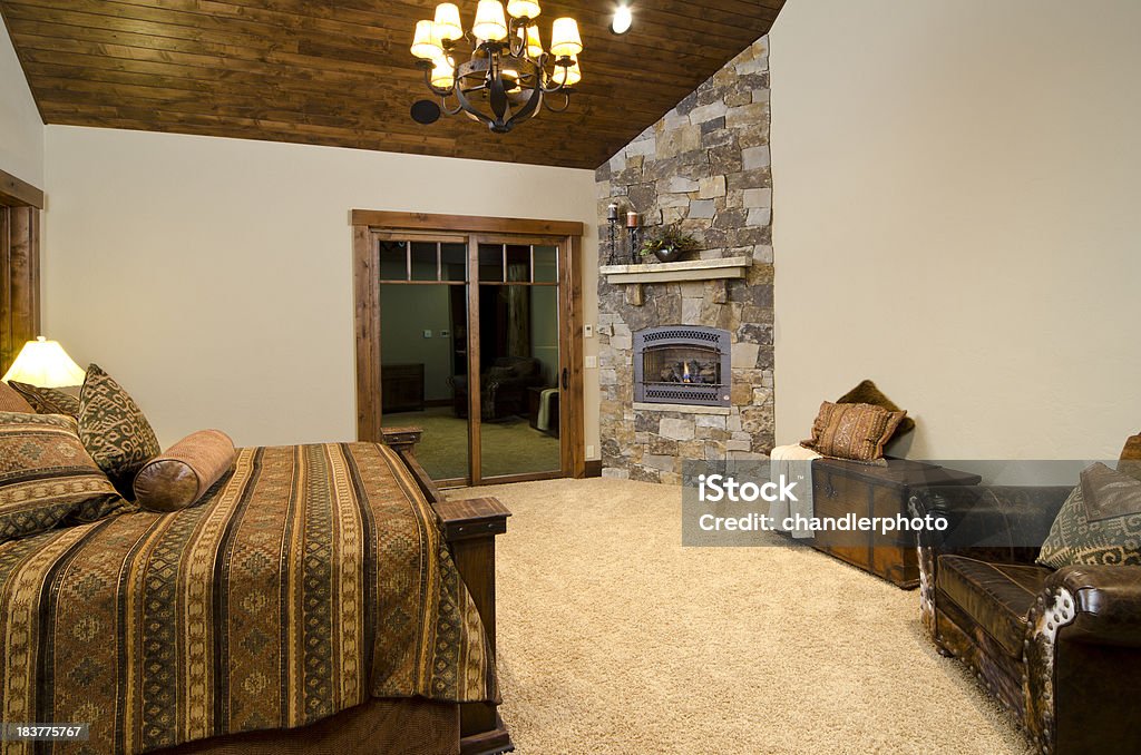 Master bedroom with fireplace This master bedroom has a brick wall with a fireplace. Architectural Feature Stock Photo