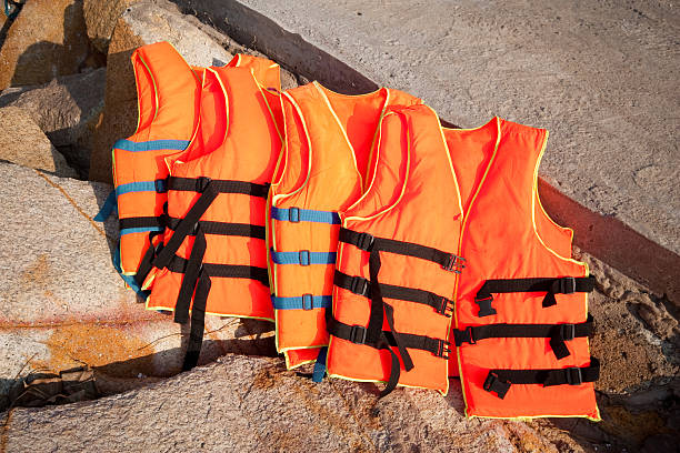 orange rescue jackets on the background of rocks stock photo