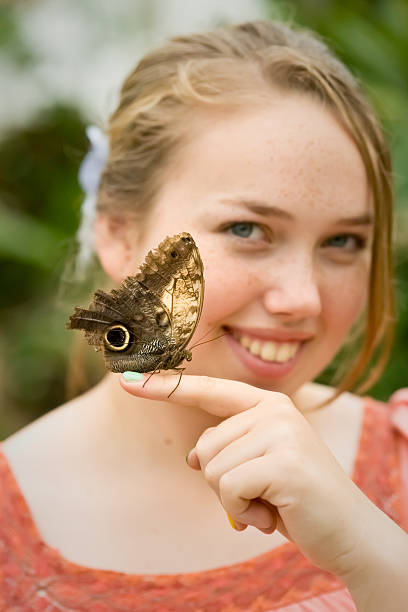 istock Girl with butterfly (Caligo memnon) on her finger 183776290