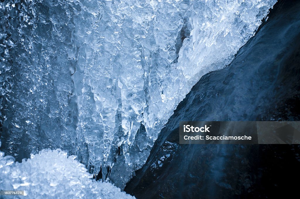 Icicles and cascade Icicles frame a winter cascade. Beauty In Nature Stock Photo