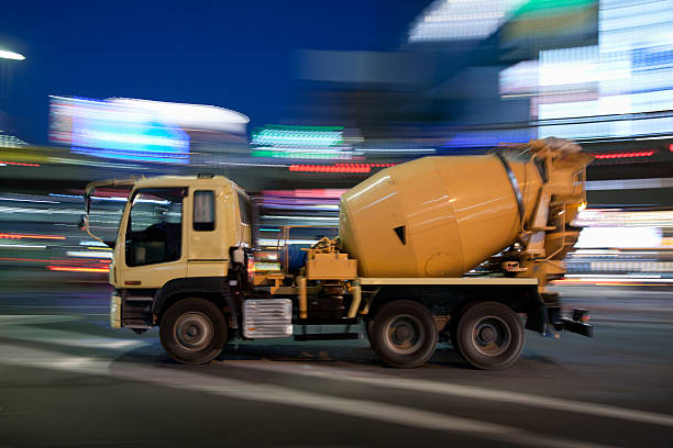 Cement mixer speeds through Tokyo at night stock photo