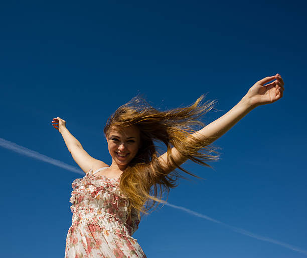 istock girl with raised hands 183776560