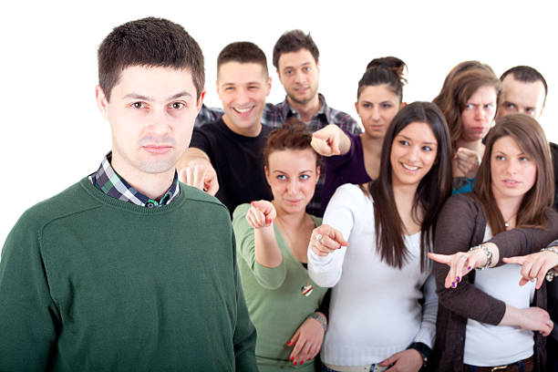 istock Crowd pointing fingers at a young man 183776828