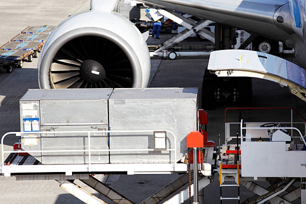 Loading cargo to airplane stock photo