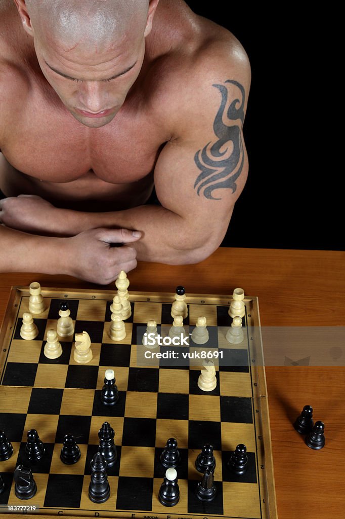 Powerful chess Powerful shirtless guy playing chess Adult Stock Photo
