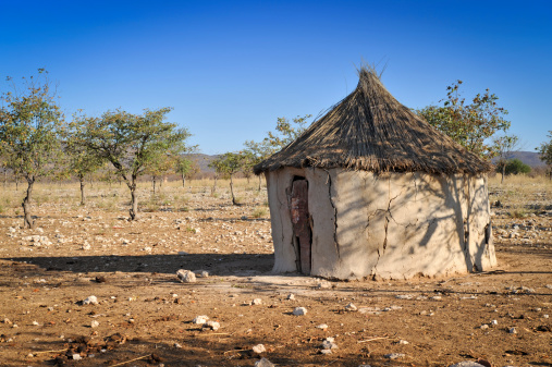 Traditional Himba hut made with mud and branches in the Kunene region in a village near Opuwo, Kaokoveld,Namibia.