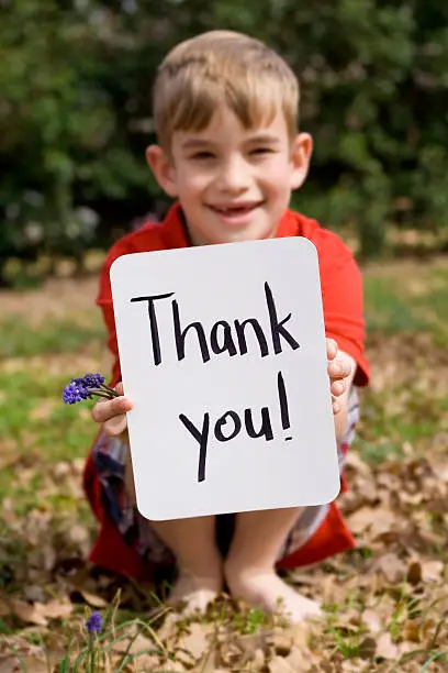 Photo of Elementary Age Boy Holding Thank You Sign