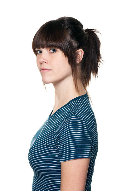 Young Woman "Portrait of casual woman, side view, against white background." bangs hair stock pictures, royalty-free photos & images